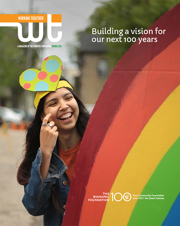 Cover of the a magazine featuring a youth standing by a rainbow parade float