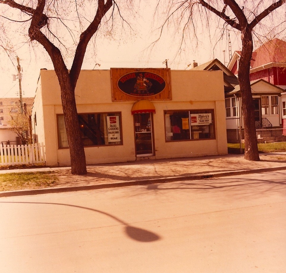 A film photo with a yellow tinge of the exterior of India Gardens.