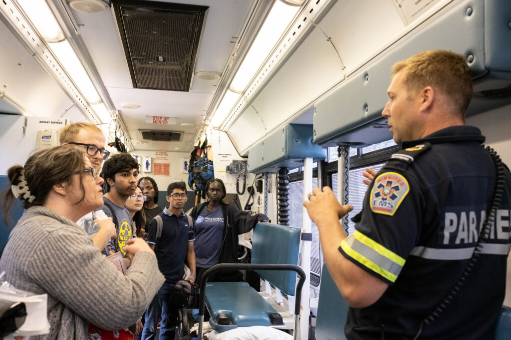 A group of Summer Internship Program participants take part in a presentation inside Winnipeg's Major Incident Response vehicle.