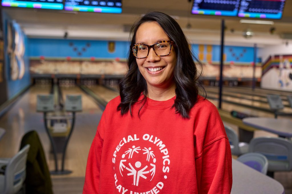 Karen Dela Cruz smiles at a bowling alley during a Special Olympics Manitoba event.