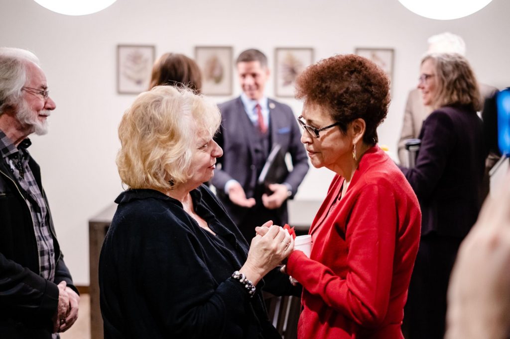Wilma Derksen speaks with Betty Ross during a Candace House gathering.