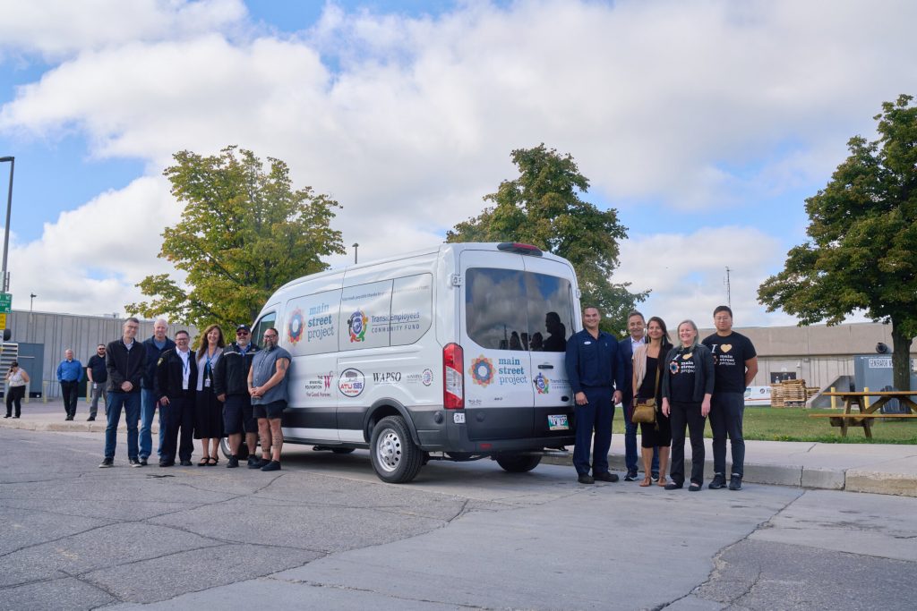 Transit and Main Street Project employees standing with new Outreach Van