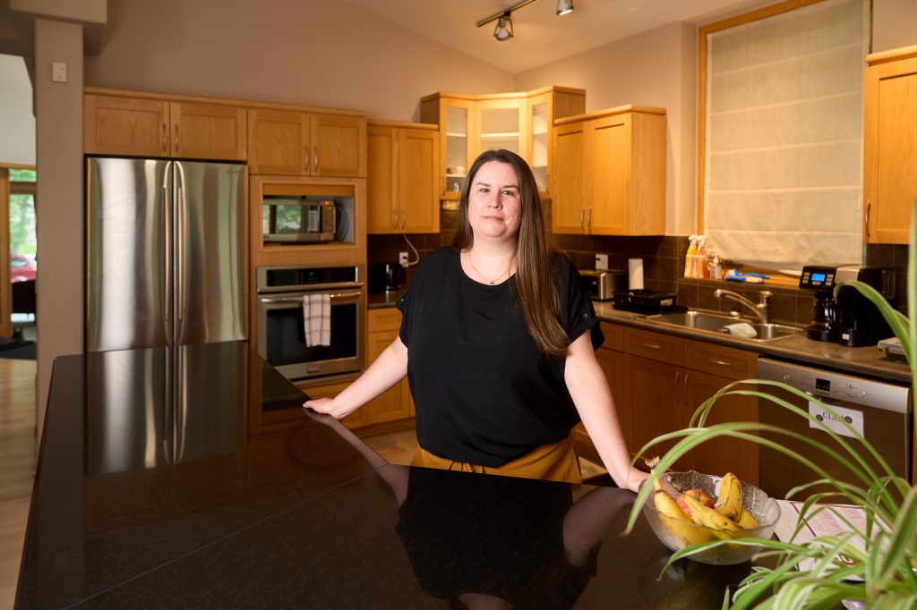 Cindy Foster, Executive Director of Regenesis Centre standing in a kitchen.