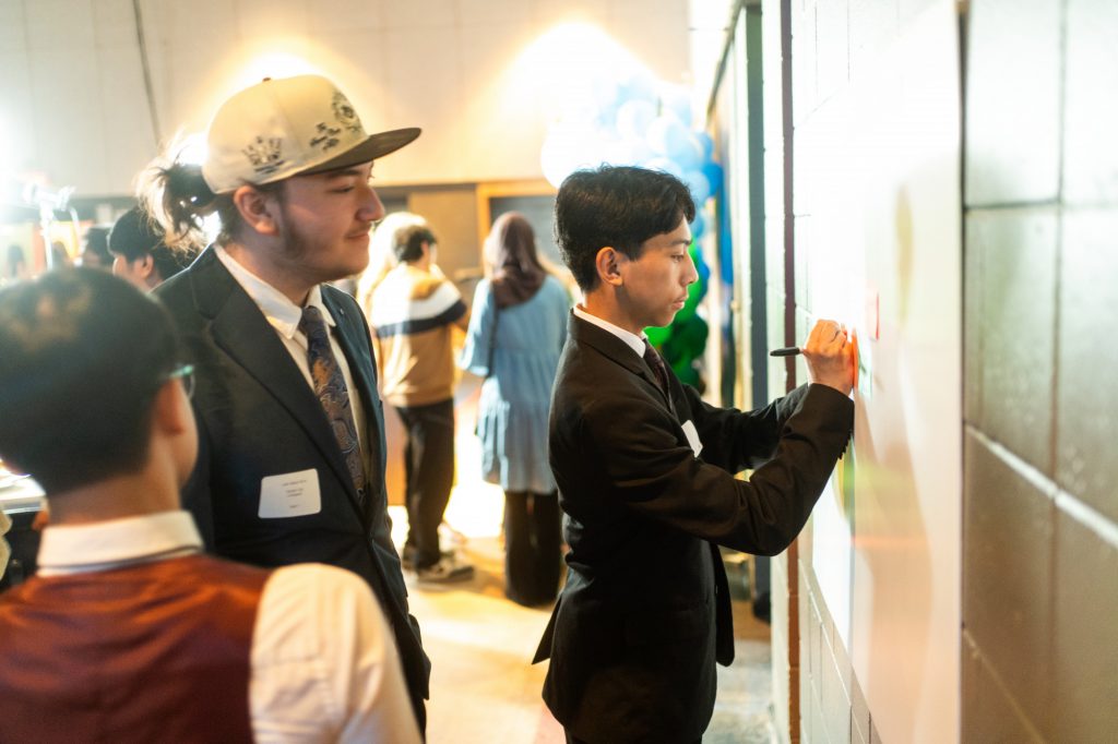 Students writing on a wall.